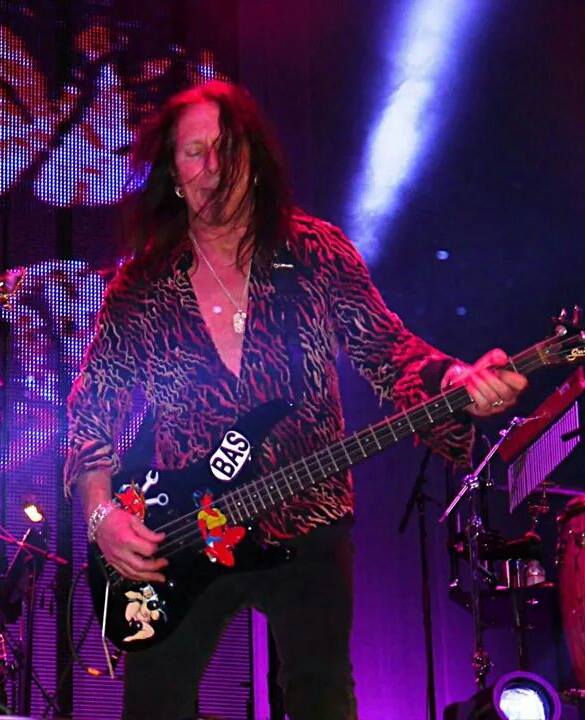 Barry Dunaway playing bass under pink stage lights with .38 Special
