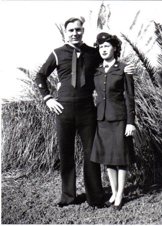 Vintage black and white photo of a sailor and a woman in uniform